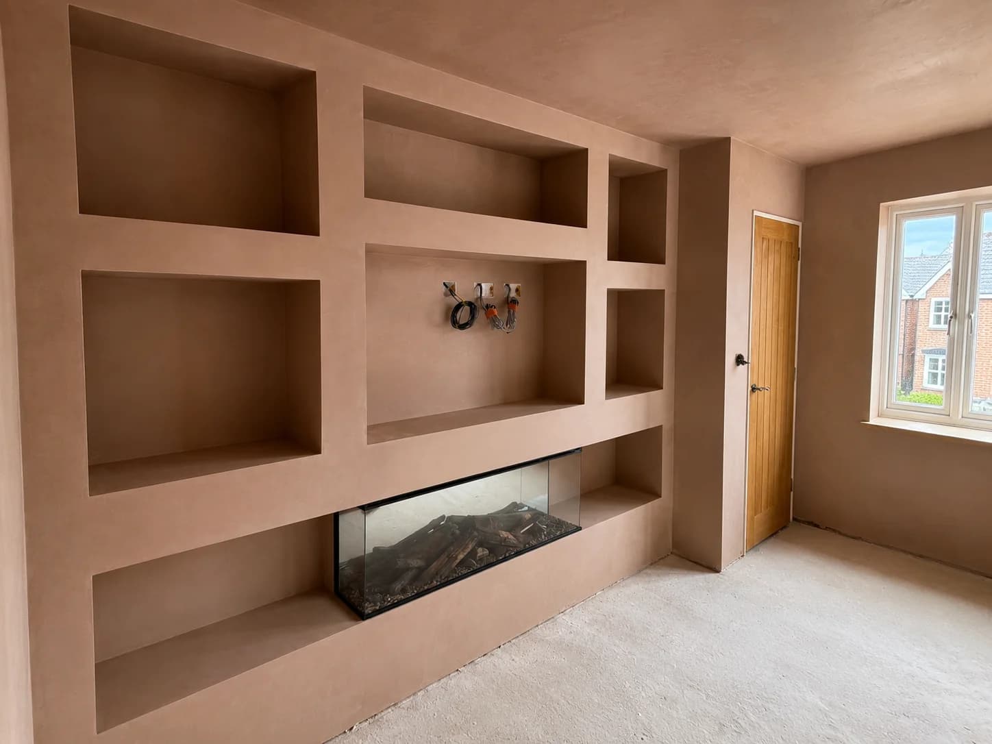 Freshly plastered media wall completed by SJT Plastering in Derby
